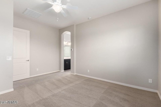 spare room featuring ceiling fan and light carpet