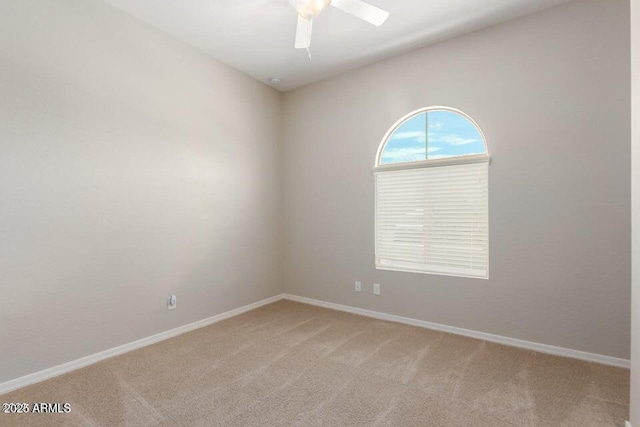 carpeted empty room featuring ceiling fan