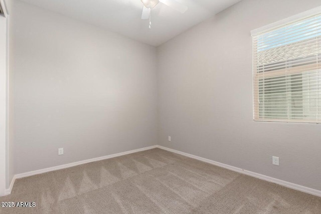 empty room featuring light colored carpet and ceiling fan