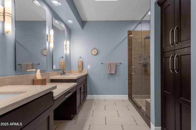 bathroom featuring a shower with door and vanity