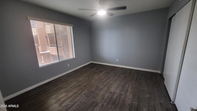 4704 E Paradise Village Pkwy N Unit 211, Phoenix, AZ 85032 - unfurnished bedroom with dark wood-style flooring, baseboards, and a ceiling fan