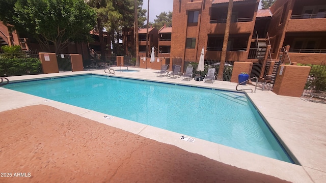4704 E Paradise Village Pkwy N Unit 211, Phoenix, AZ 85032 - community pool featuring a patio and stairway