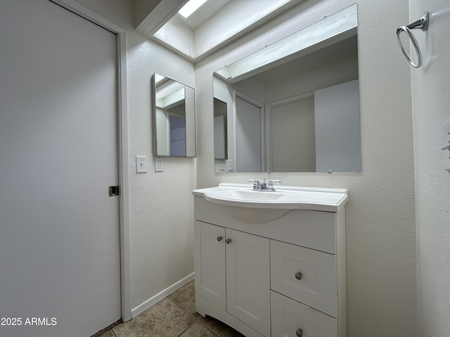 6842 S 42nd Pl, Phoenix, AZ 85042 - bathroom with vanity, tile patterned floors, and baseboards
