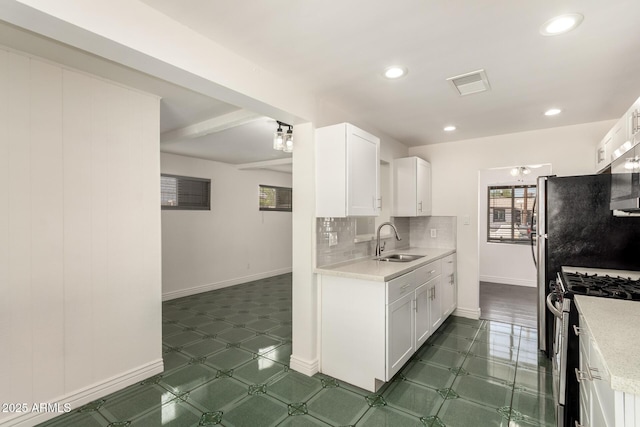 5635 N 35th Dr, Phoenix, AZ 85019 - kitchen with a sink, appliances with stainless steel finishes, white cabinets, baseboards, and recessed lighting
