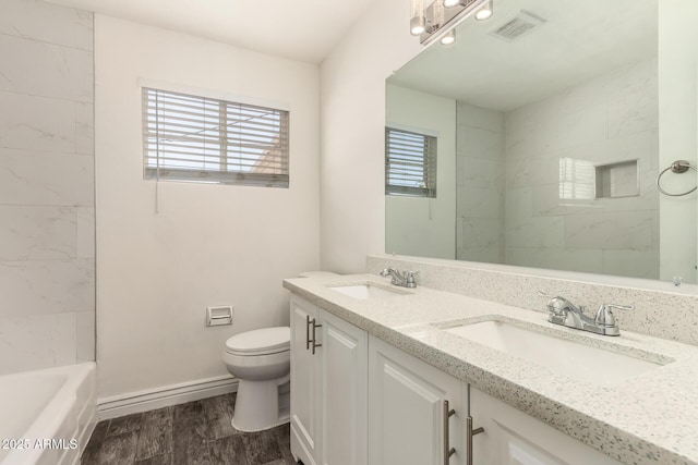 5635 N 35th Dr, Phoenix, AZ 85019 - bathroom featuring double vanity, toilet, wood finished floors, and baseboards
