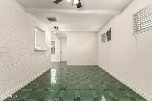5635 N 35th Dr, Phoenix, AZ 85019 - unfurnished room with brick wall, ceiling fan, beam ceiling, and baseboards