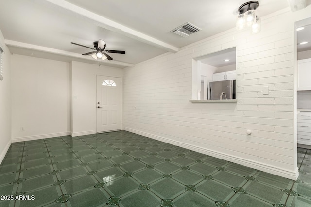 5635 N 35th Dr, Phoenix, AZ 85019 - entryway with baseboards, ceiling fan, brick wall, and beam ceiling