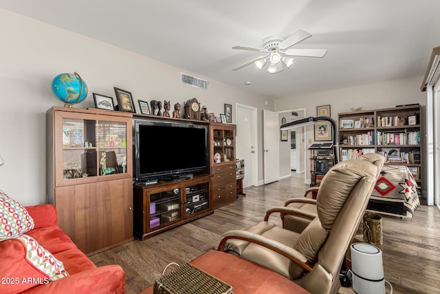 living room featuring hardwood / wood-style flooring and ceiling fan