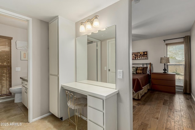 bathroom featuring vanity, toilet, and hardwood / wood-style flooring