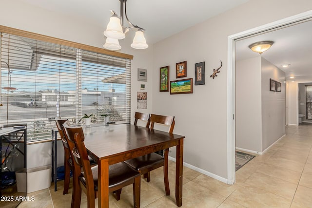 tiled dining area with plenty of natural light and a notable chandelier