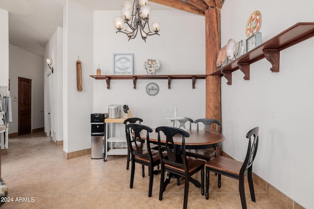 dining area with light tile patterned flooring and a chandelier