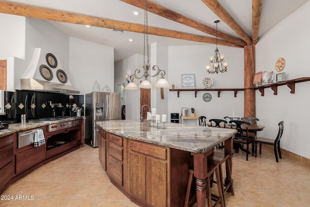 kitchen with a center island with sink, light stone countertops, light tile patterned floors, stainless steel fridge with ice dispenser, and pendant lighting