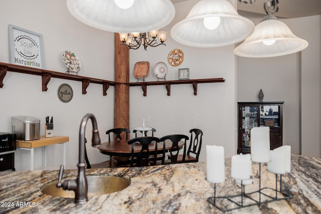 dining room with a chandelier and sink