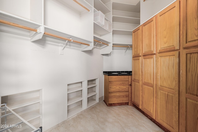 walk in closet featuring light tile patterned flooring