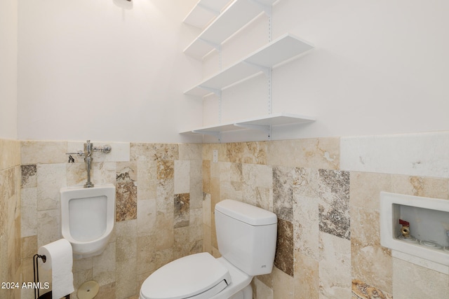 bathroom featuring tile walls and toilet