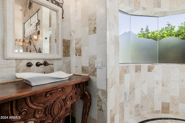 bathroom with vanity and tile walls