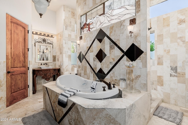 bathroom with tile walls, vanity, and separate shower and tub