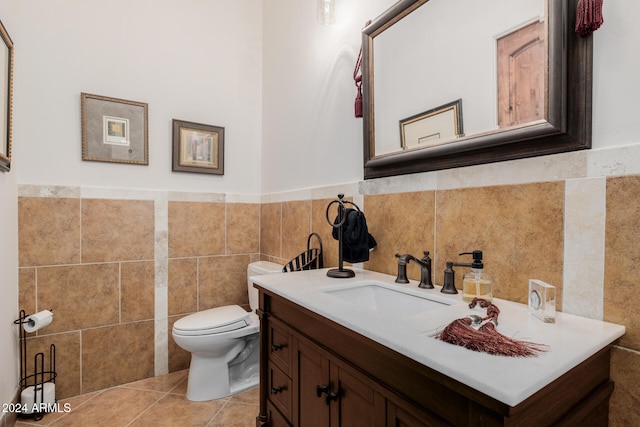 bathroom featuring tile patterned flooring, vanity, toilet, and tile walls