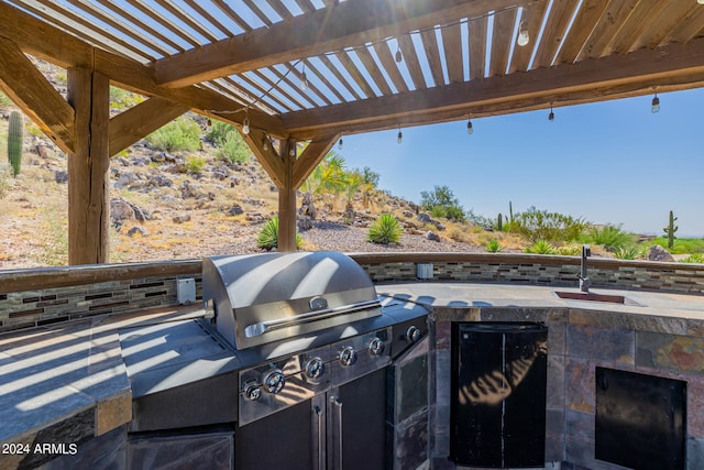 view of patio / terrace featuring sink, a pergola, and exterior kitchen