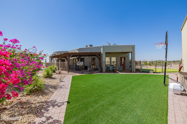 back of property featuring a patio, a yard, and a pergola