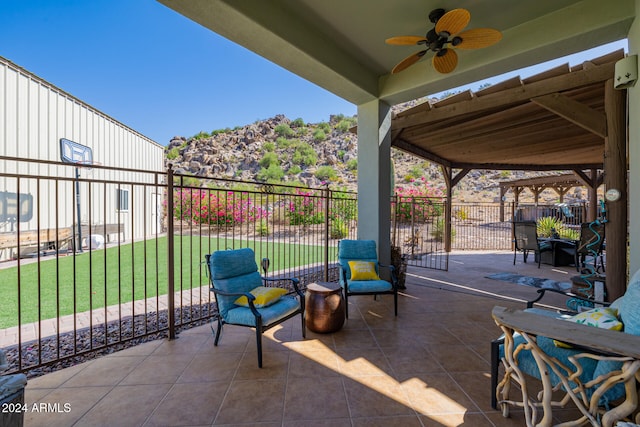 view of patio / terrace with ceiling fan and a gazebo