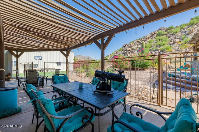 view of patio / terrace with a pergola and a mountain view