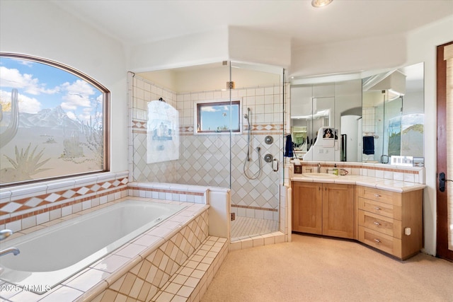 bathroom featuring vanity and separate shower and tub