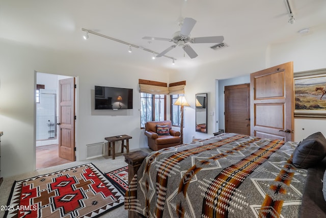 carpeted bedroom featuring rail lighting and ceiling fan