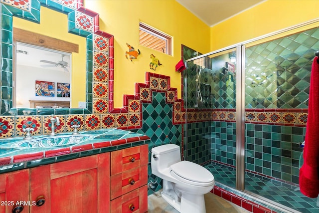 bathroom with tile patterned flooring, vanity, an enclosed shower, and toilet