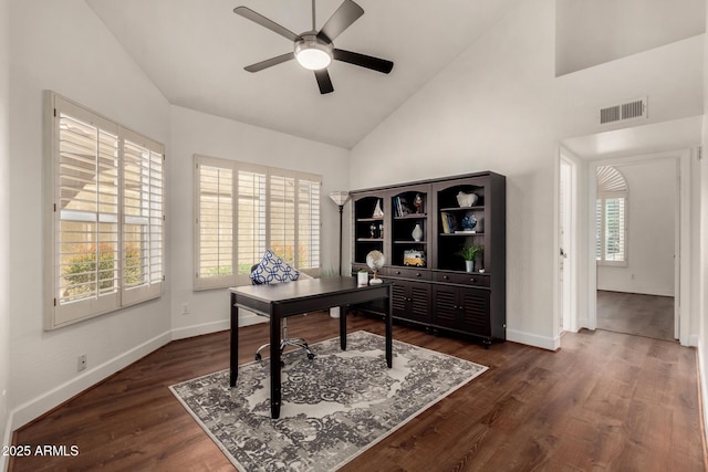 office area with dark wood-style floors, baseboards, visible vents, high vaulted ceiling, and ceiling fan