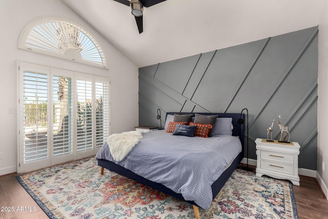 bedroom featuring lofted ceiling, a ceiling fan, wood finished floors, baseboards, and access to exterior