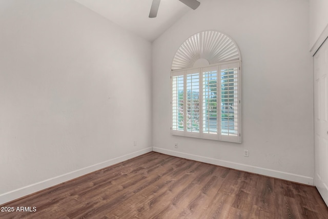 unfurnished room featuring baseboards, wood finished floors, a ceiling fan, and vaulted ceiling