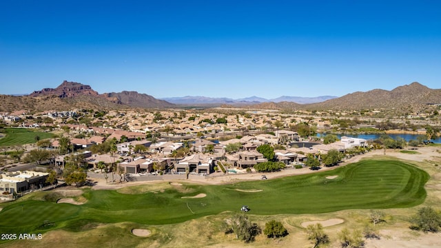 exterior space with a residential view, a water and mountain view, and view of golf course