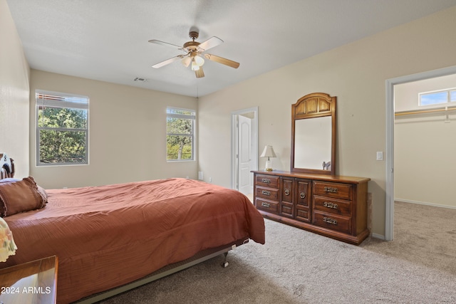 carpeted bedroom with a closet and ceiling fan