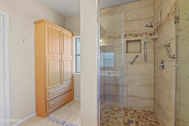 bathroom with a shower with door