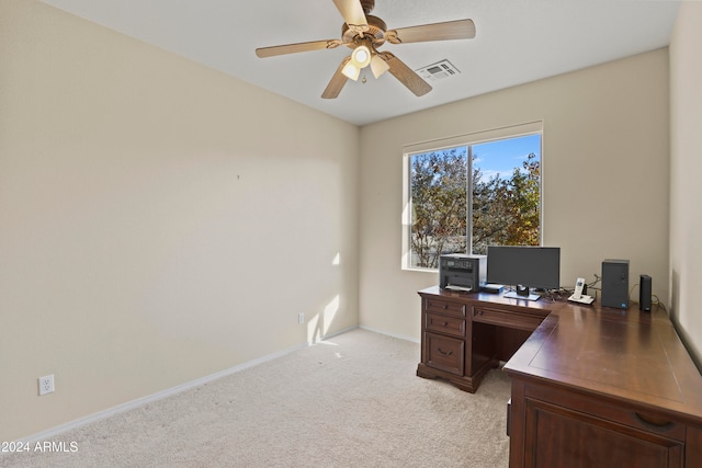 carpeted office space with ceiling fan