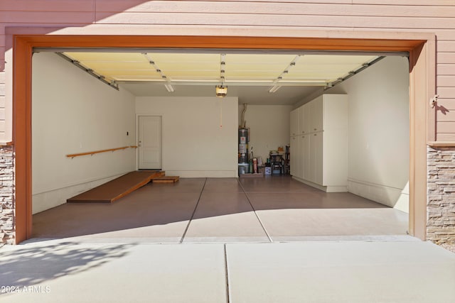 garage featuring a garage door opener and water heater