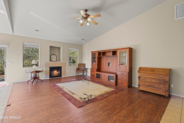 living room featuring a fireplace, a wealth of natural light, hardwood / wood-style floors, and ceiling fan