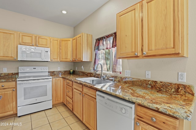 kitchen with light stone countertops, sink, white appliances, and light brown cabinets