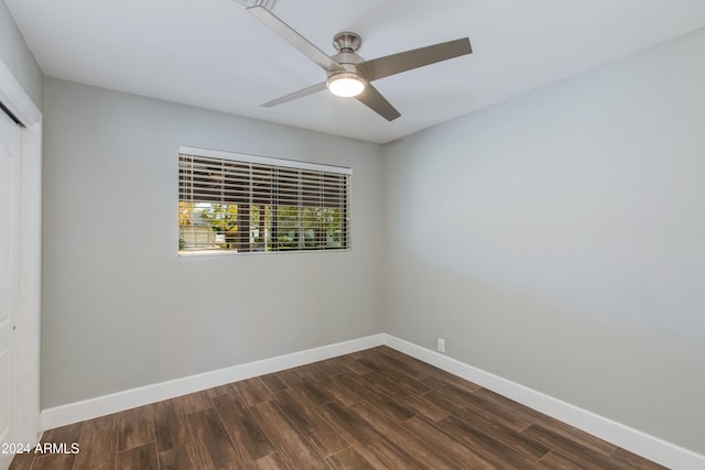 empty room with dark wood-type flooring and ceiling fan