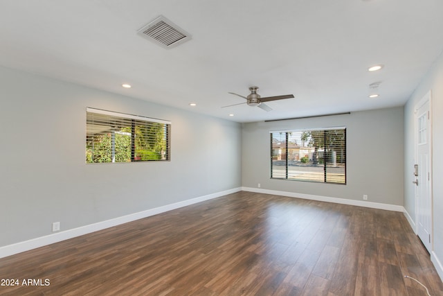 empty room featuring ceiling fan and dark hardwood / wood-style floors