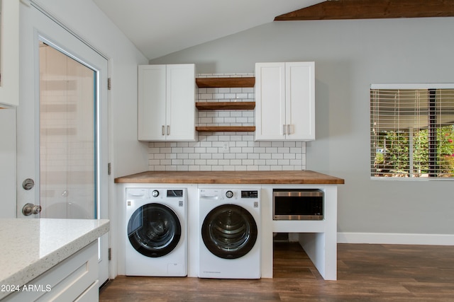 laundry area featuring cabinets, dark hardwood / wood-style flooring, and washer and clothes dryer