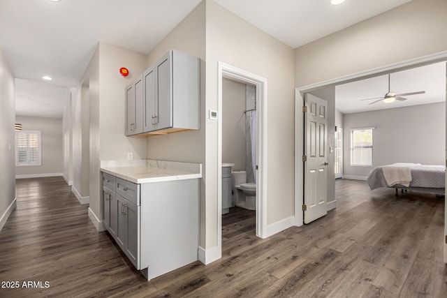 hallway with recessed lighting, baseboards, and wood finished floors