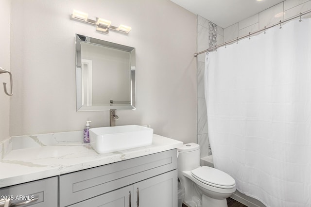 full bath featuring shower / bath combo with shower curtain, toilet, and vanity