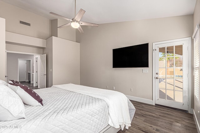 bedroom with visible vents, baseboards, lofted ceiling, wood finished floors, and access to outside