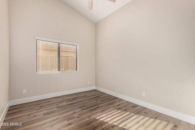 spare room featuring a ceiling fan, lofted ceiling, wood finished floors, and baseboards