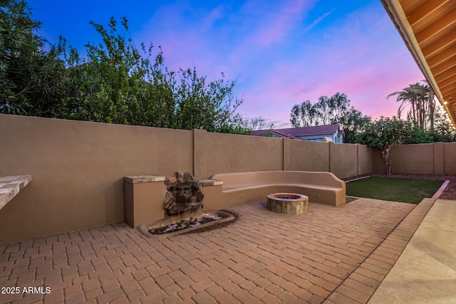 view of patio featuring a fenced backyard and an outdoor fire pit