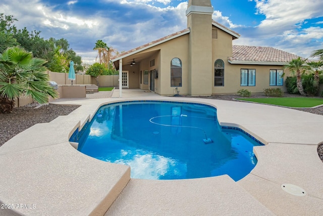 view of swimming pool with a patio, a fenced backyard, a fenced in pool, and ceiling fan