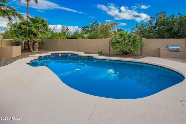 view of swimming pool featuring a patio area, area for grilling, a fenced backyard, and a fenced in pool