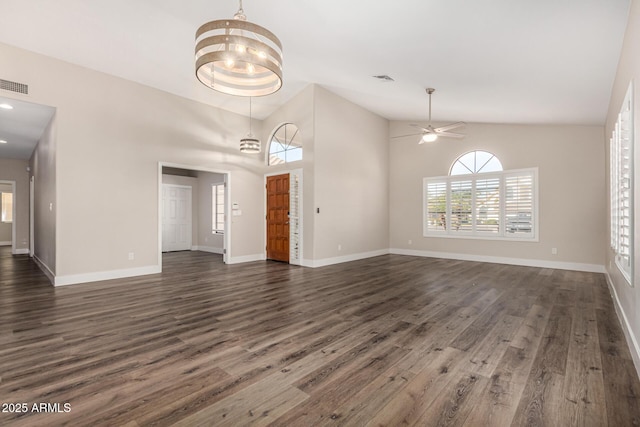 unfurnished living room featuring ceiling fan with notable chandelier, dark wood-type flooring, baseboards, and visible vents